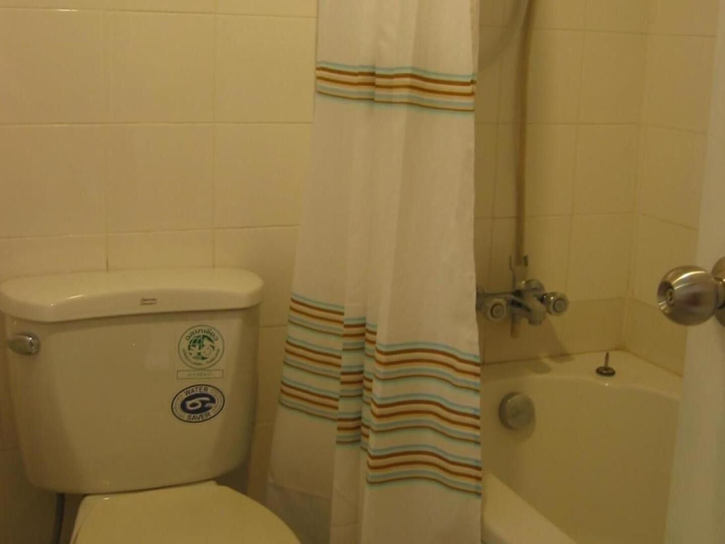 Une salle de bain avec des toilettes, une douche et une baignoire.