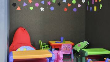 A children's play area with colorful furniture and decorations.