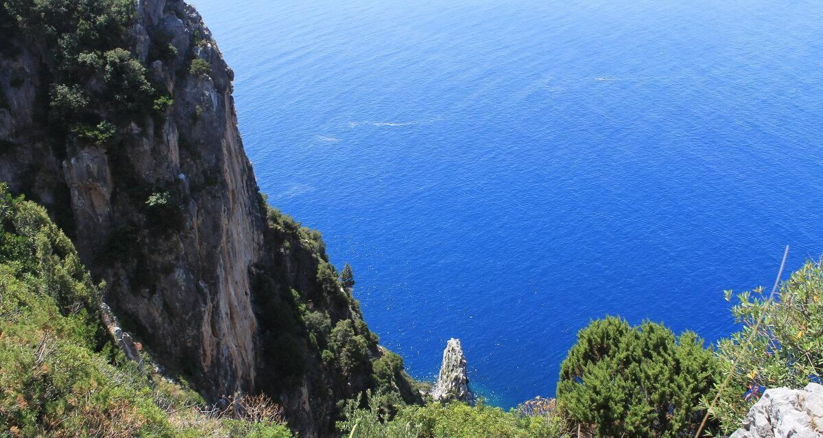 Una scogliera a picco sul mare con vista sull'oceano.
