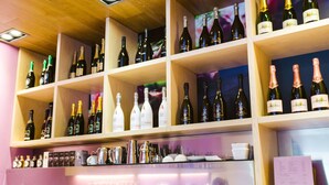 A bar with shelves of wine bottles and glasses.