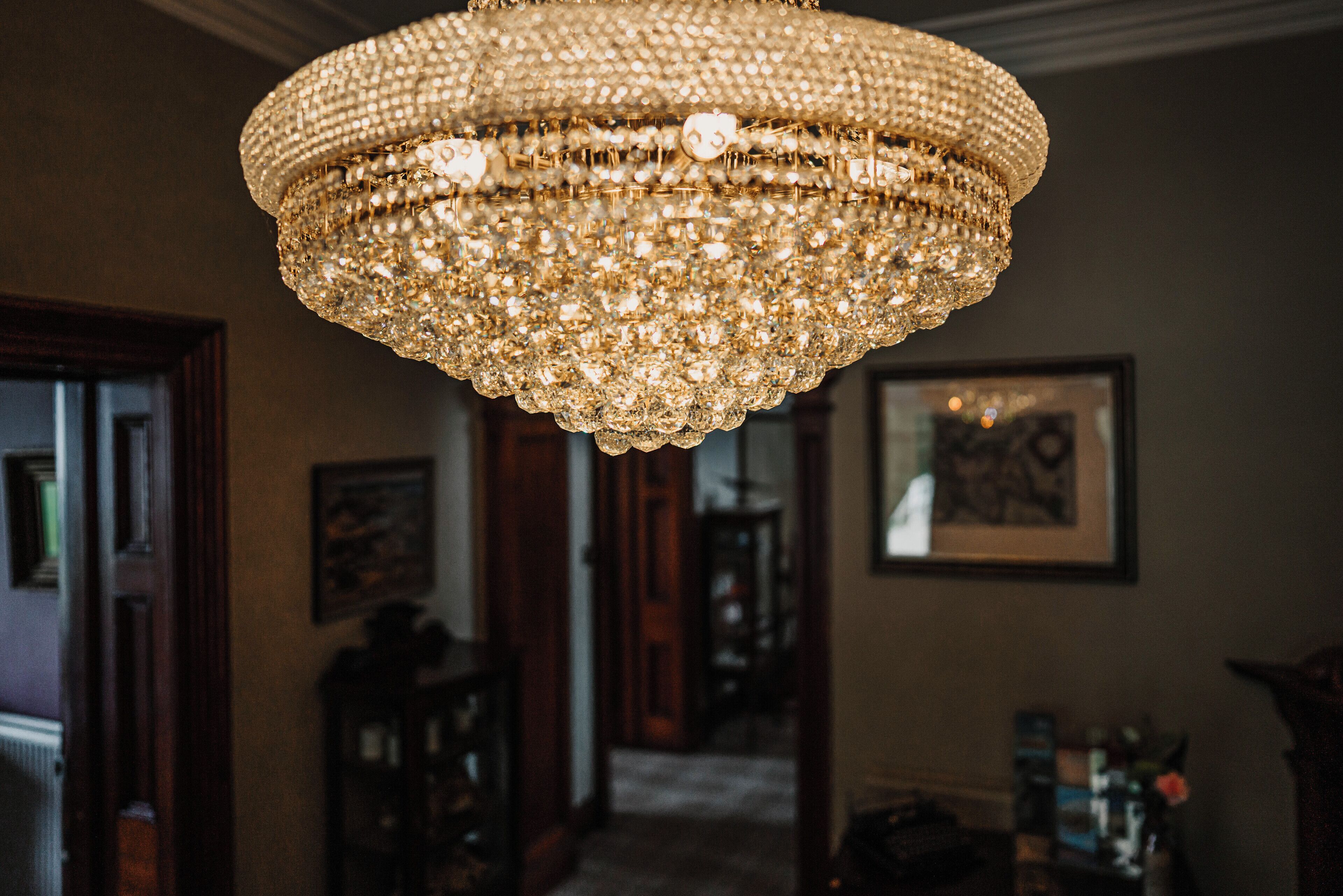 A chandelier with multiple tiers of crystals hanging from the ceiling.