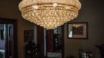 A chandelier with multiple tiers of crystals hanging from the ceiling.