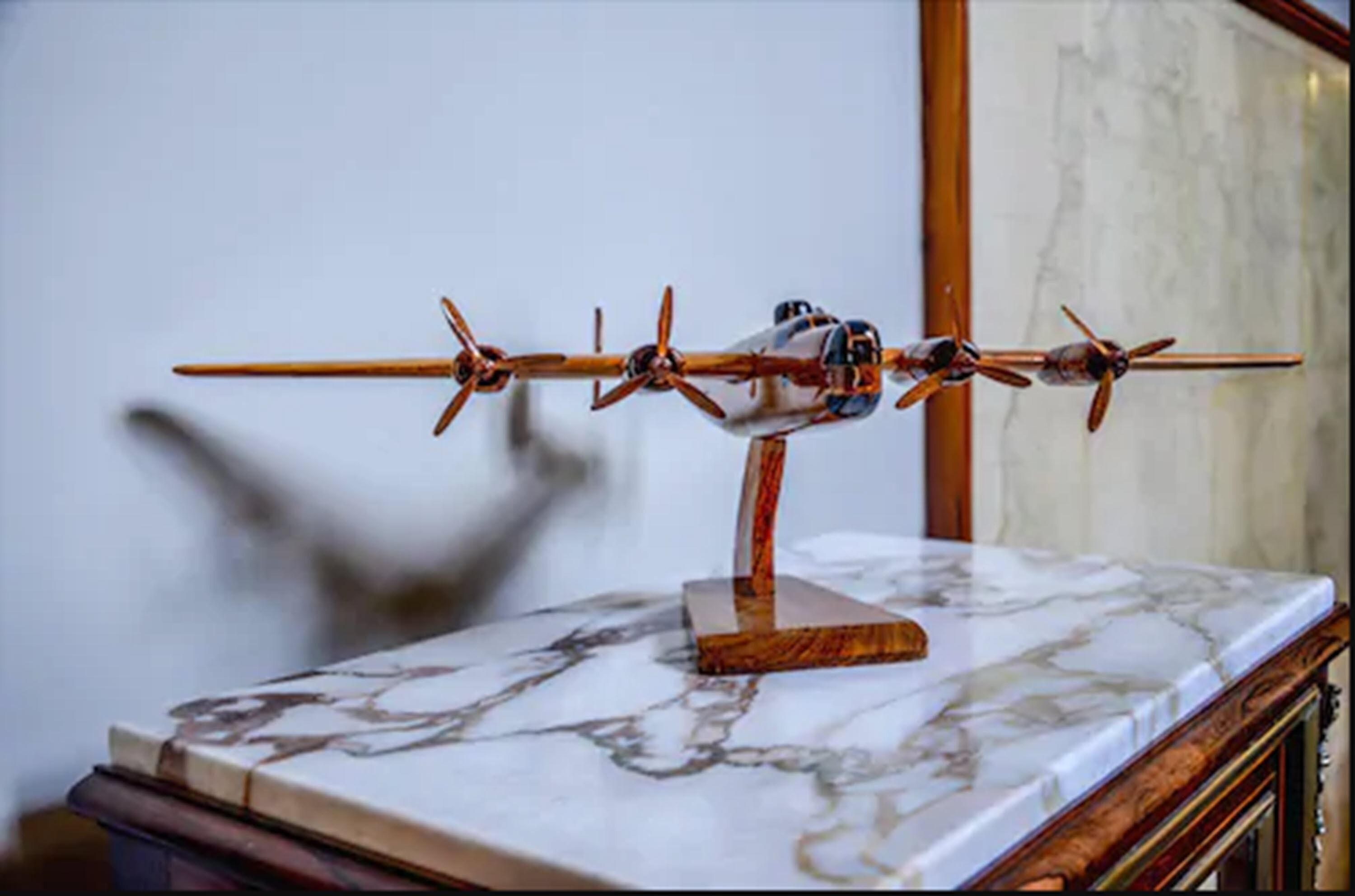 A model airplane on a marble table.
