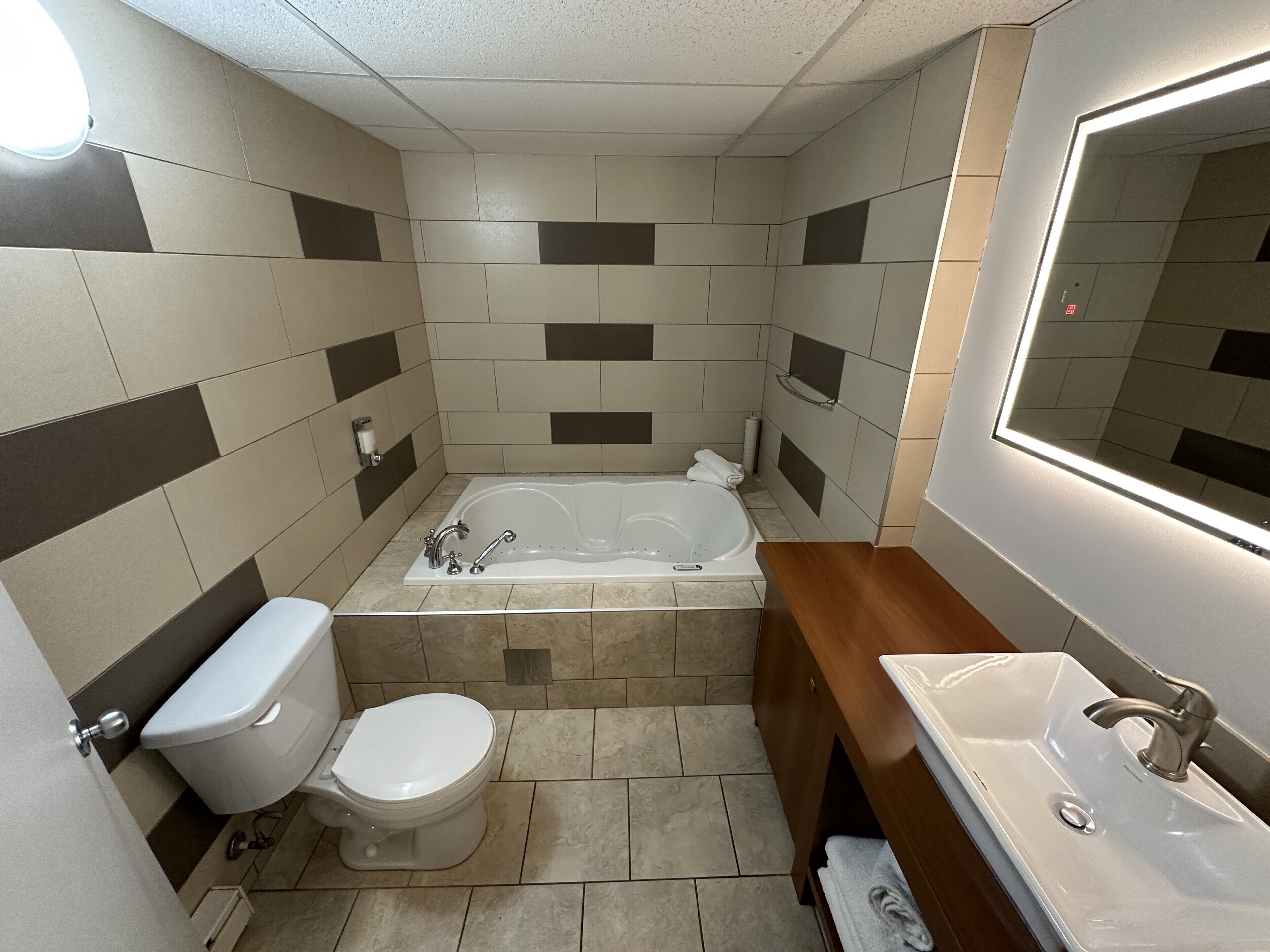 A bathroom with a bathtub, toilet, and sink.
