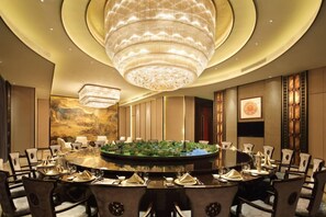 A conference room with a round table, chairs, and a large chandelier. - Wanda Realm Fuyang (Fuyang)