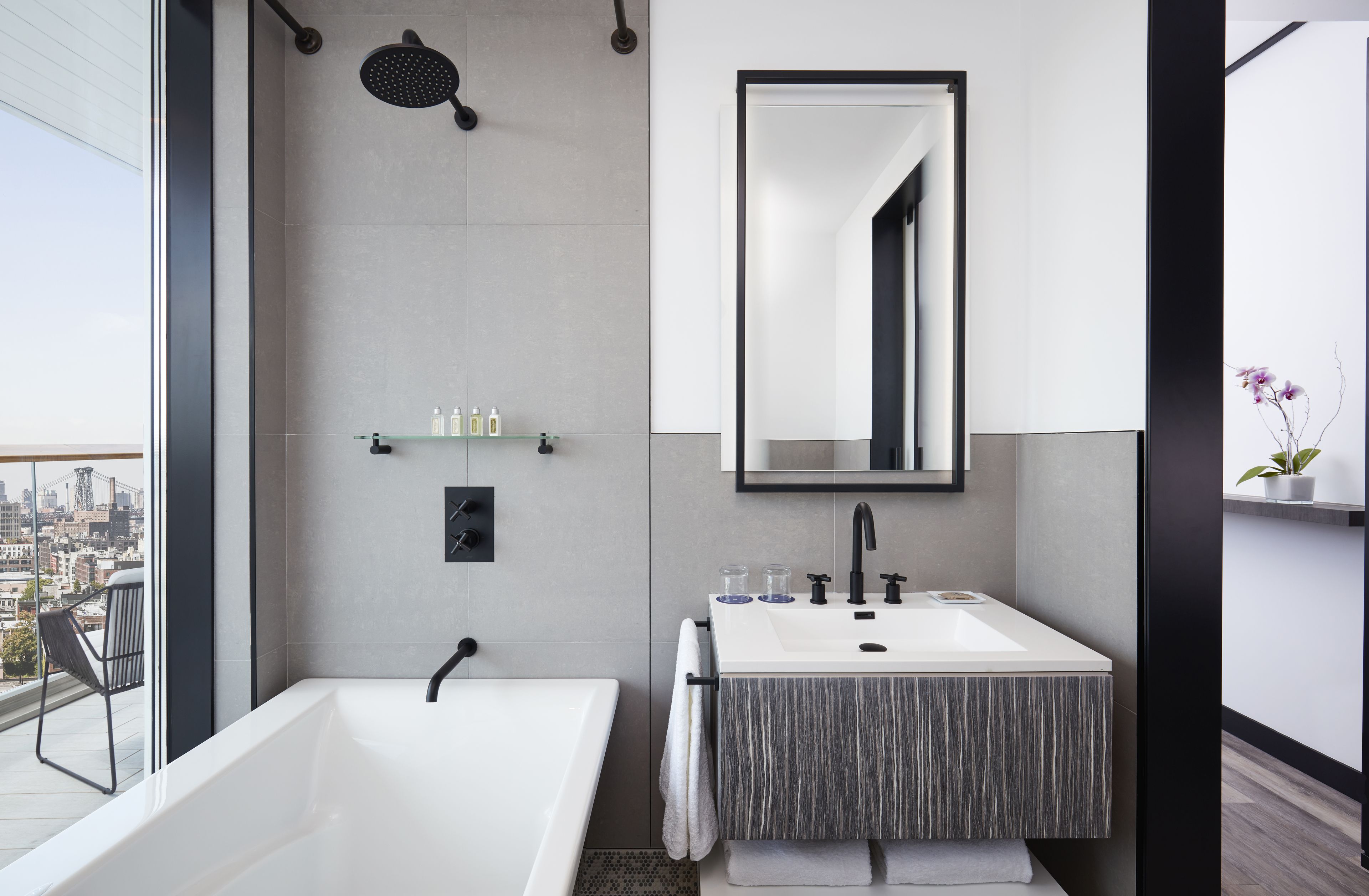 A modern bathroom with a bathtub, a shower, and a sink.