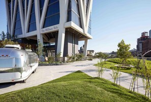 A modern building with 'The Williams Vale' signage, a paved walkway, and a green landscaped area.