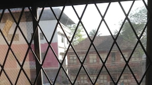 A window with a diamond-patterned grille. - St.Antonys Lodge Ernakulam Market (Kanayannur)