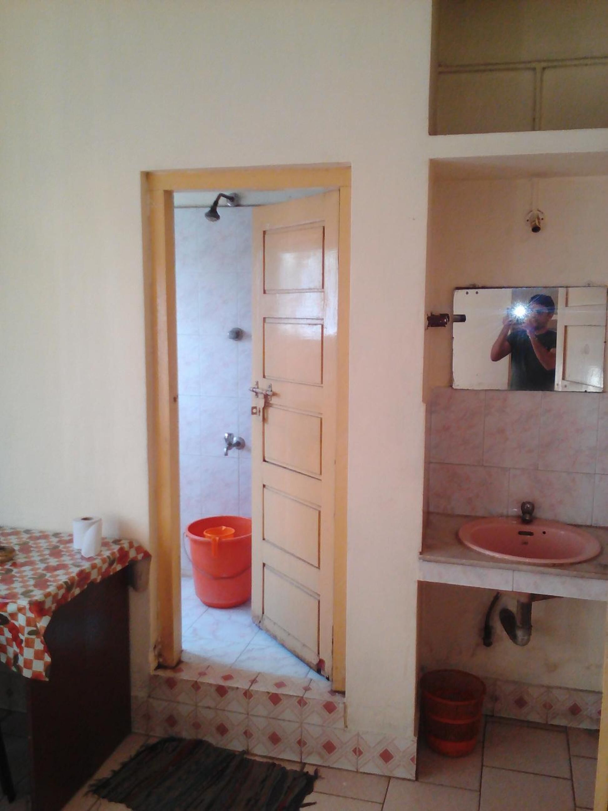 A bathroom with a sink, mirror, and toilet.