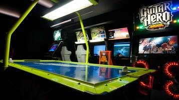 Experience the ultimate gaming destination with a variety of arcade machines, including Guitar Hero.