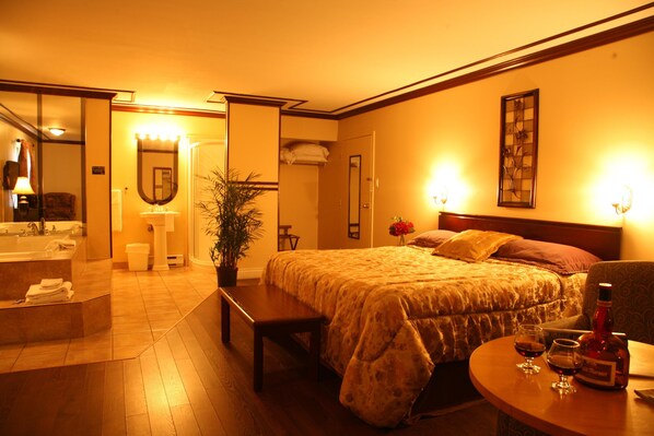 Relax in a stylish room with a plush bed, bedside table, and potted plant.