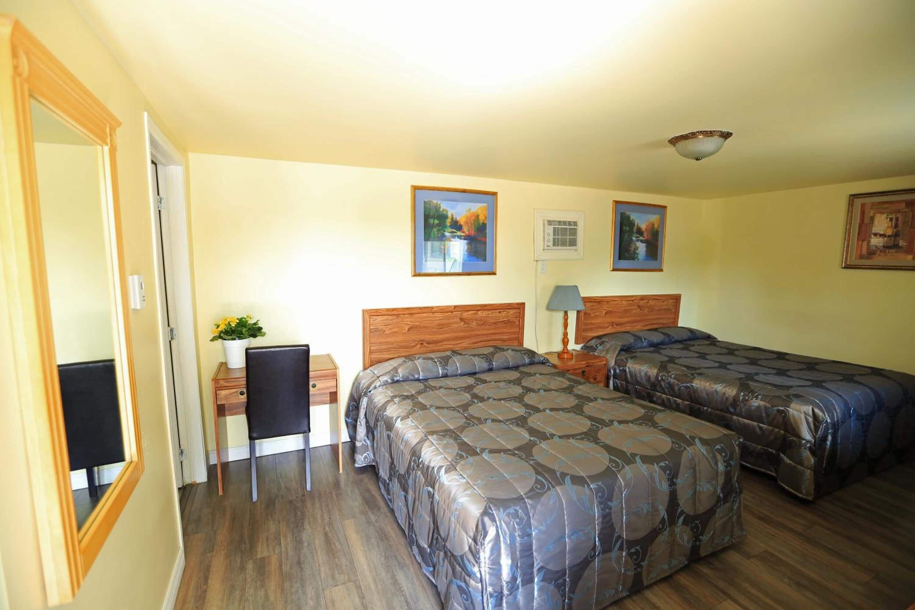 economy room, 2 queen beds (motel) | desk, laptop workspace, iron/ironing board, free wifi