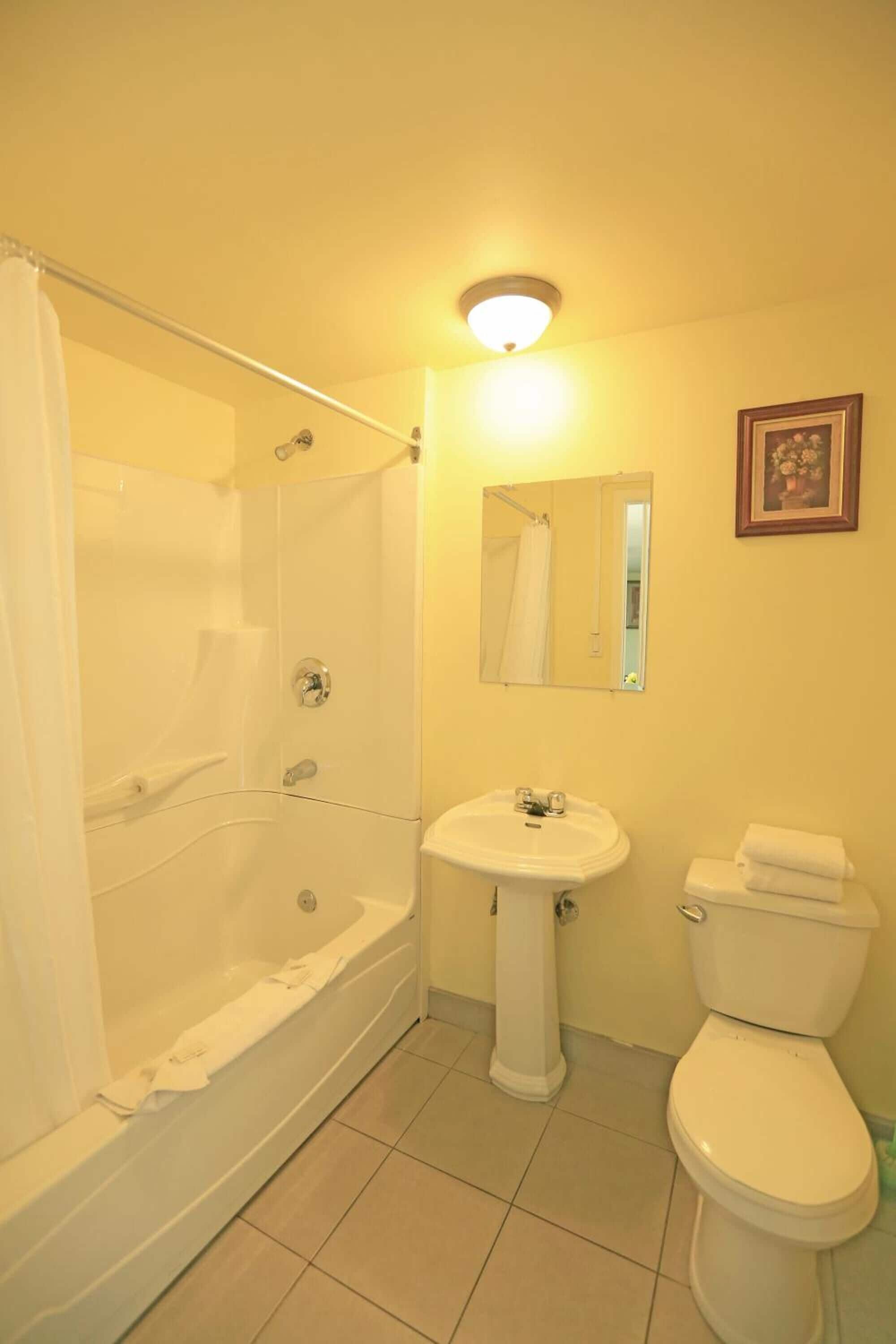 economy room, 2 queen beds (motel) | bathroom | free toiletries, hair dryer, towels