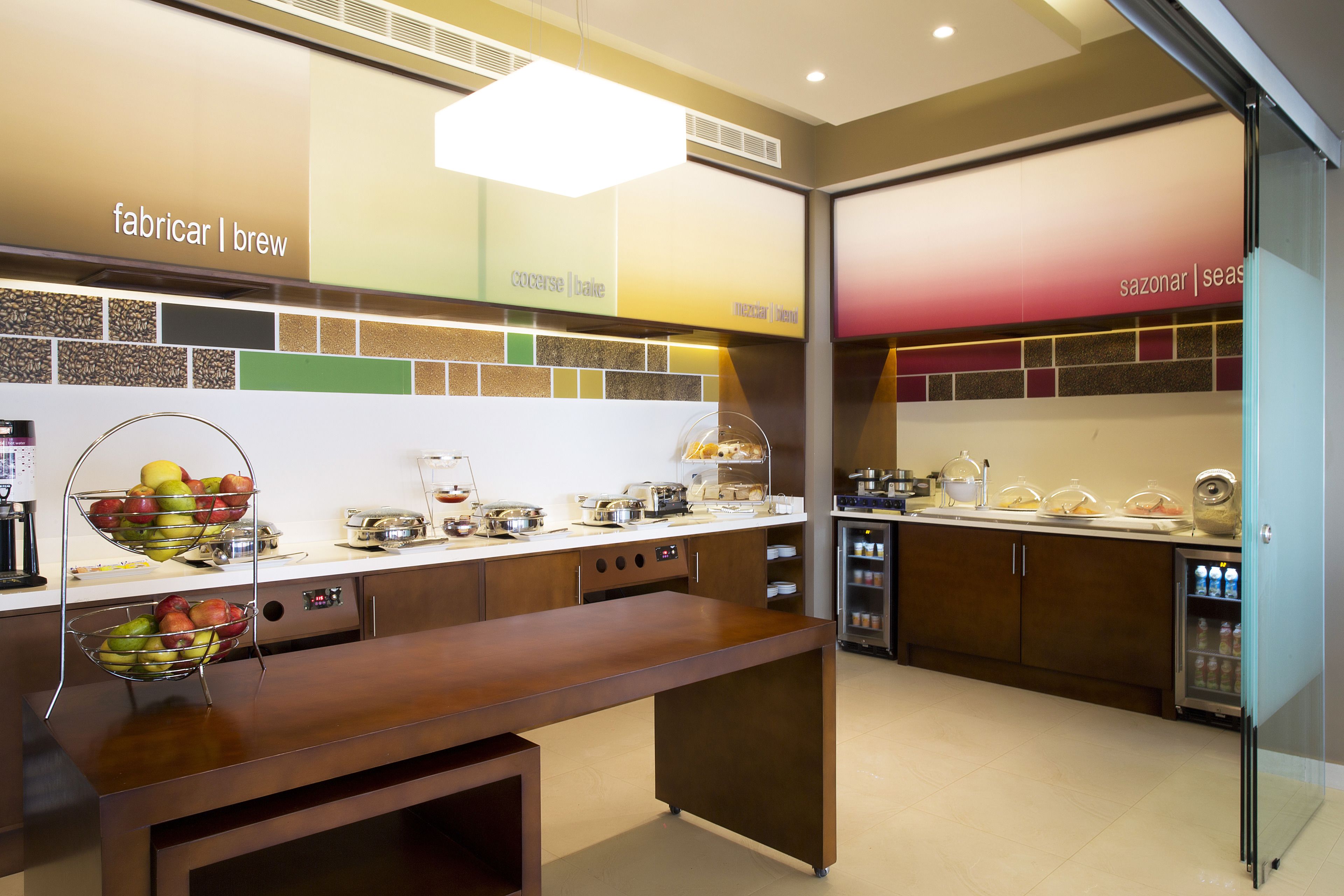 Una cocina moderna con encimera de madera, una cesta de fruta y una cafetera.