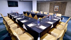 A conference room with a long table, chairs, and water bottles. - The Theme Jaipur (Jaipur)