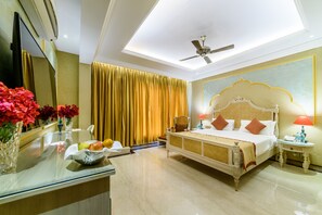 A hotel room with a bed, bedside table, and a large mirror.