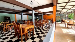 A restaurant with checkered flooring, wooden tables, and chairs. - Supsangdao Resort (Krabi)