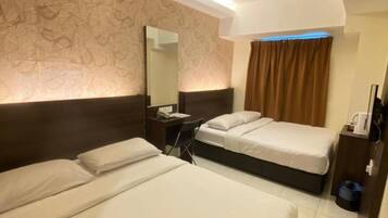 A hotel room with two beds, a desk, a chair, a mirror, and a window with curtains.