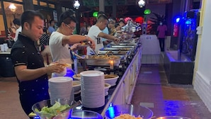 A buffet setup with various dishes and a serving line. - Puteri Bayu Beach Resort (Kampong Pasir Bogak)