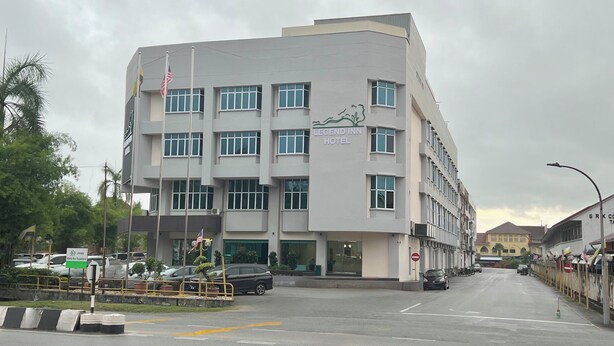 A multi-story hotel with a modern design, featuring a prominent sign for the Legend Inn Hotel.