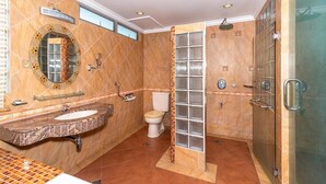 A modern bathroom with a marble vanity, a toilet, and a glass-enclosed shower area. - Holiday Park (KOTA KINABALU)