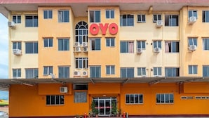 A multi-story hotel building with the name "OYO" prominently displayed. - Holiday Park (KOTA KINABALU)