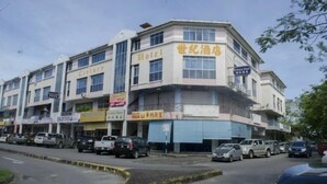 A multi-story hotel with a sign indicating it is a hotel. - Century Hotel Inanam (Kota Kinabalu)
