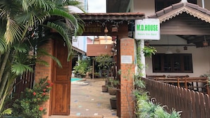 A traditional house with a sign indicating it is for rent. - MD House (Chiang Mai)