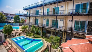 A multi-story building with a swimming pool, balconies, and a courtyard. - Prince (Chiang Mai)