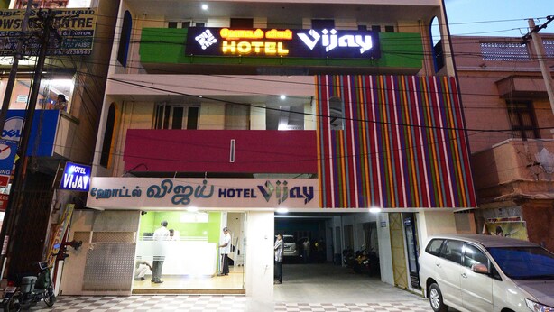A multi-story hotel with a prominent sign for "Hotel Vijay" and a visible entrance. - Hotel Vijay (Madurai)