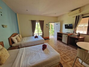 A hotel room with two beds, a desk, a television, and a kitchenette. - Rim Khao Jungle Resort Koh Lanta (Ko Lanta)