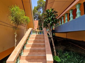 A staircase with a handrail, surrounded by greenery and a building facade. - Rim Khao Jungle Resort Koh Lanta (Ko Lanta)