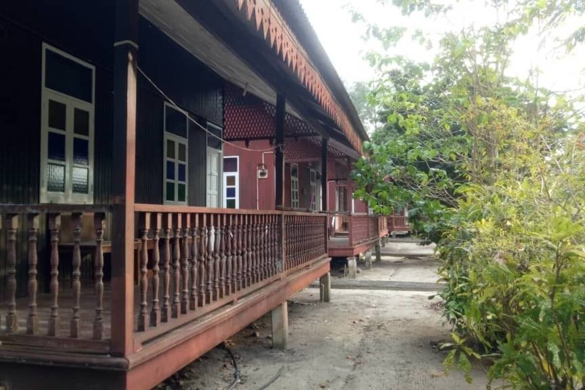 A traditional building with a wooden balcony and a door.