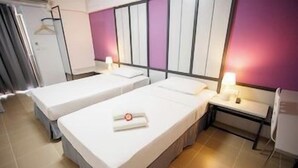 A hotel room with two beds, a desk, and a chair. - Regent Ngamwongwan (Nonthaburi)