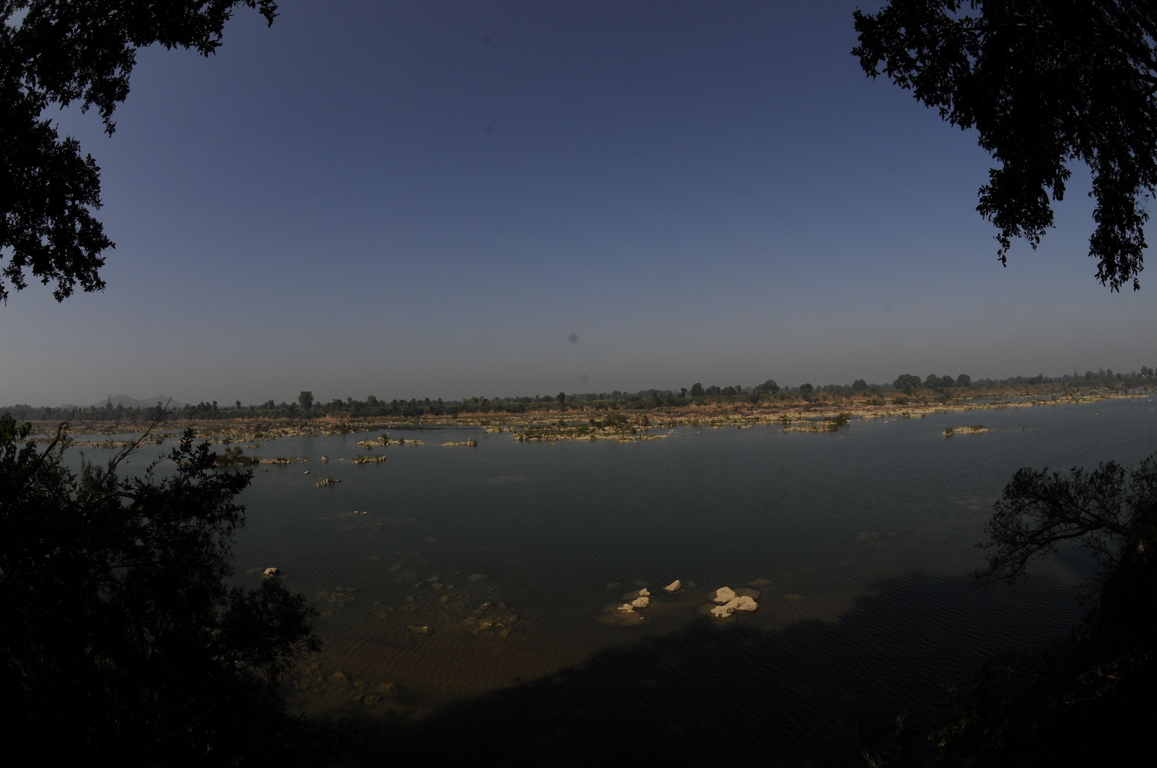 A view of a river with trees framing the scene.