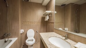 A bathroom with a toilet, sink, and shower. - Bangkok City Suite (Bangkok)