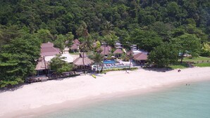 An aerial view of a resort with multiple bungalow-style buildings, a swimming pool, and a beach. - Nature Beach Resort (Ko Chang)