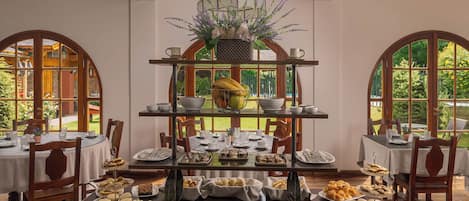 A multi-tiered buffet table with various food items and a decorative centerpiece.
