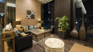 A modern living room with a sofa, coffee table, and decorative vases.