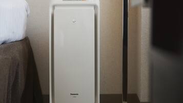 A white portable heater with the brand name 'Panasonic' on a carpeted floor.