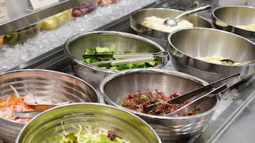 A buffet with various food items including seafood, vegetables, and salads.