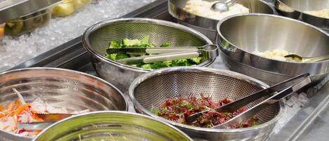 A buffet with various food items including seafood, vegetables, and salads.