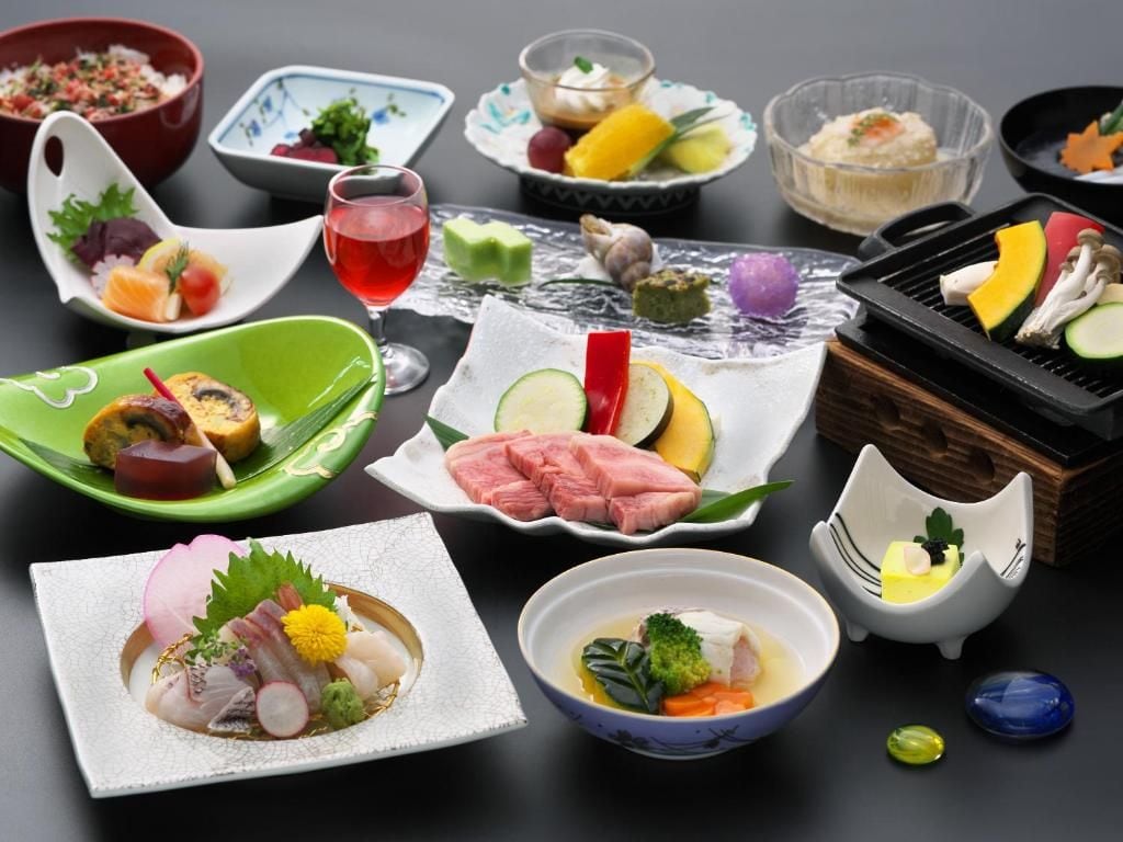 A variety of dishes and a drink on a table.