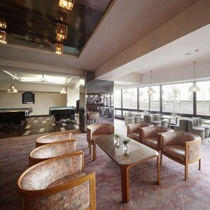 A spacious indoor area with a pool table, billiards, and seating arrangements. - Atami Tamanoyu Hotel (Shizuoka)