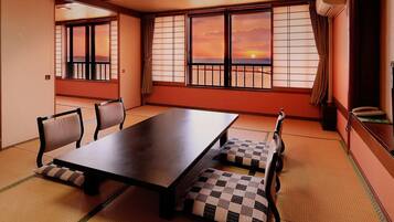 A traditional Japanese room with tatami flooring, a low table, and shoji screens.