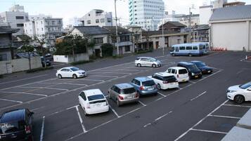 A parking lot with several cars parked in designated spaces.