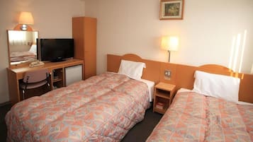 Habitación de hotel con dos camas, un escritorio con televisor, un espejo y un cuadro colgado en la pared.