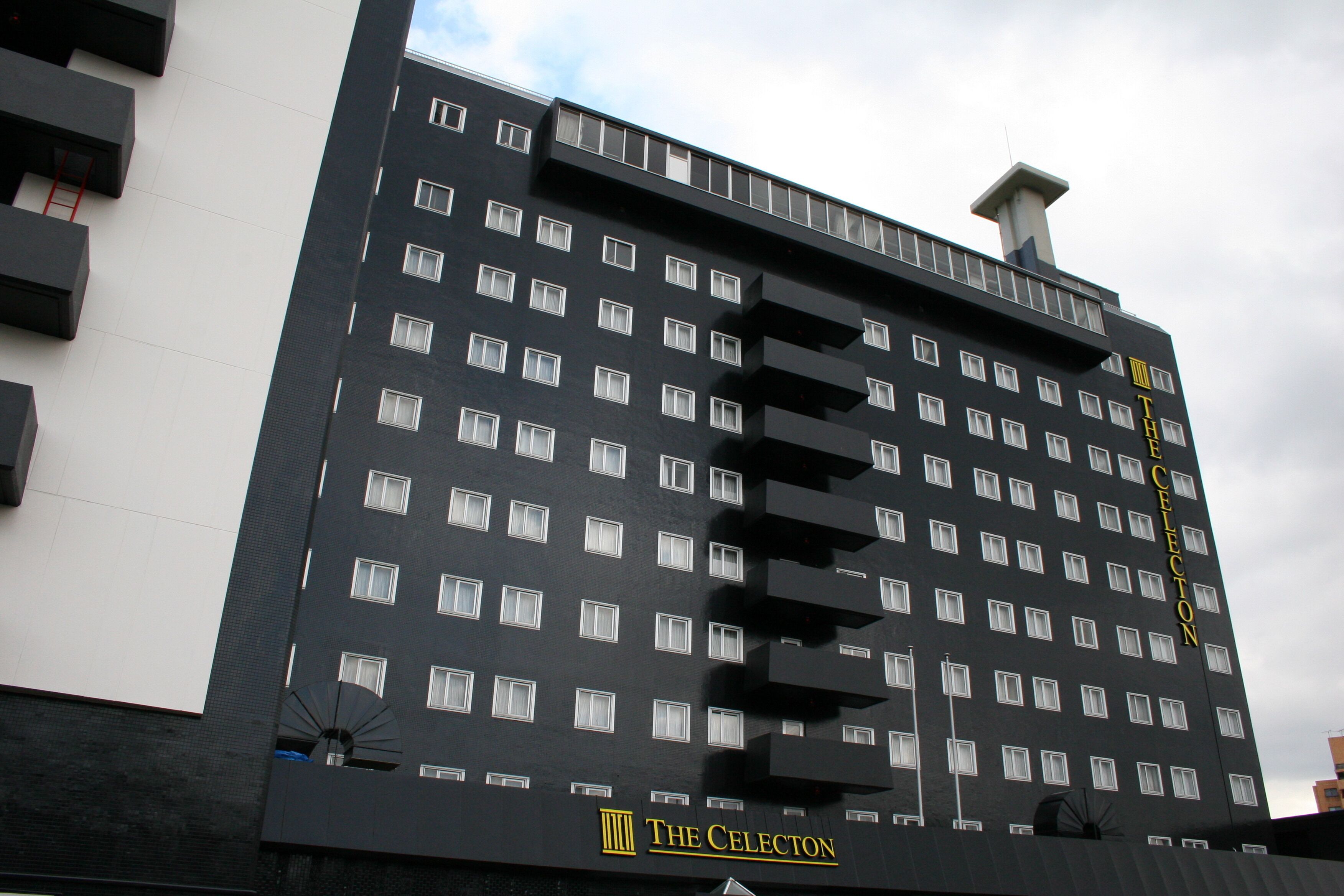 A multi-story hotel with a modern design, featuring a prominent "The Celestion" sign on the facade.