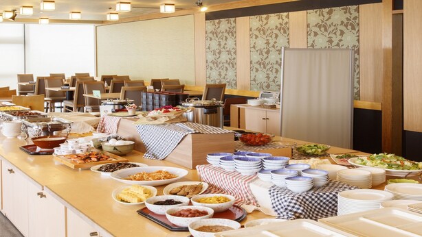A buffet setup with various food items and dishes.