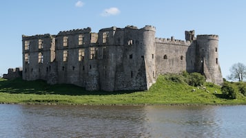A large, historic castle with multiple towers and a moat.